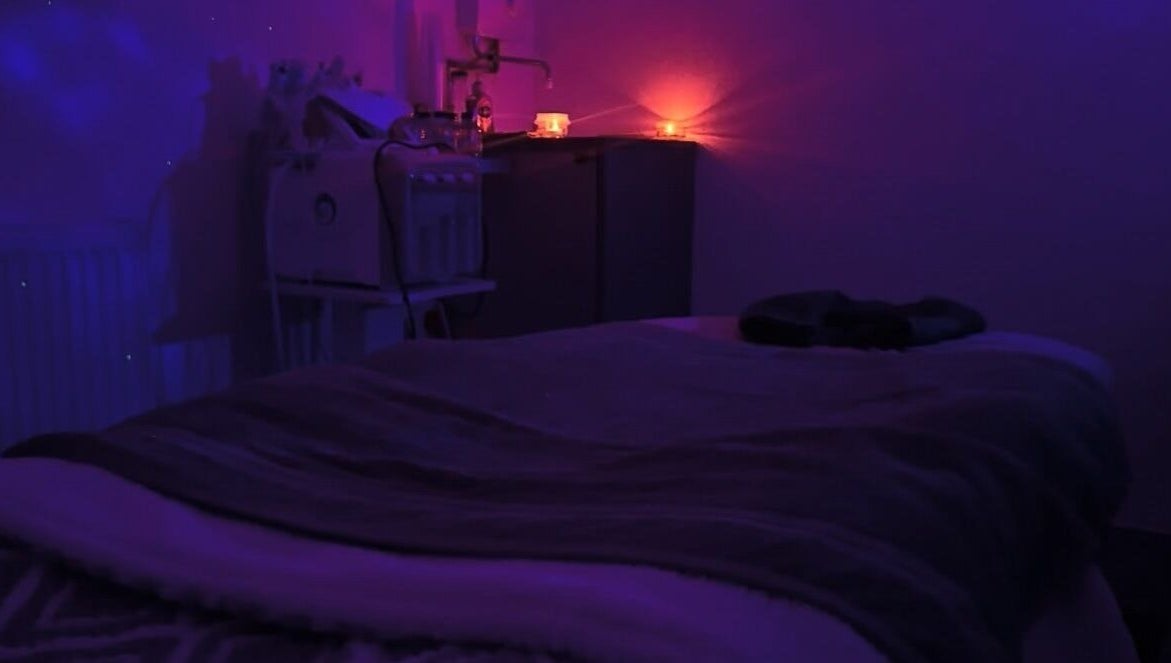 Dimly lit massage room with calming ambiance at PD Beauty Lounge, Bolton, England, GB.