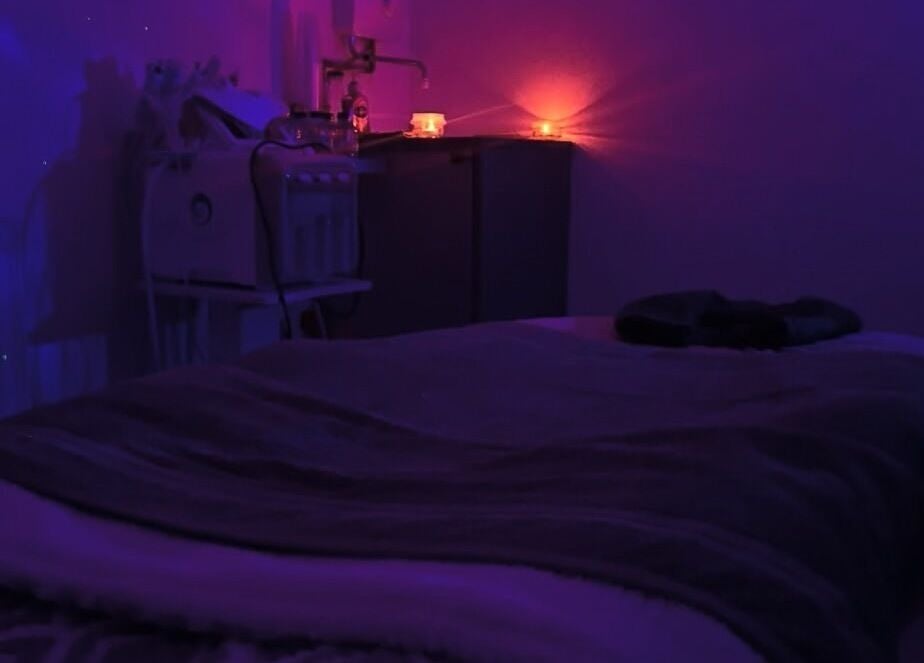 Dimly lit massage room with calming ambiance at PD Beauty Lounge, Bolton, England, GB.
