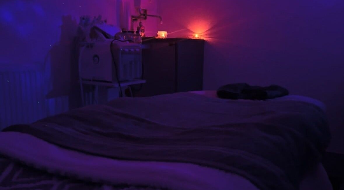 Dimly lit massage room with calming ambiance at PD Beauty Lounge, Bolton, England, GB.
