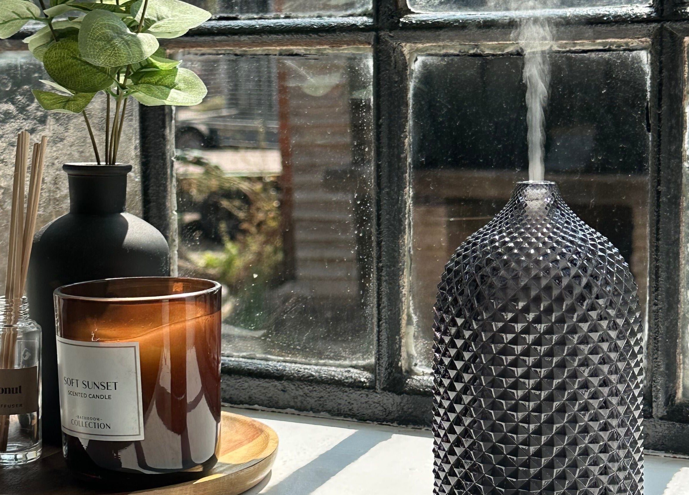 Aromatherapy setup with candle and diffuser at Nails.co, Beech Hill, England, GB.