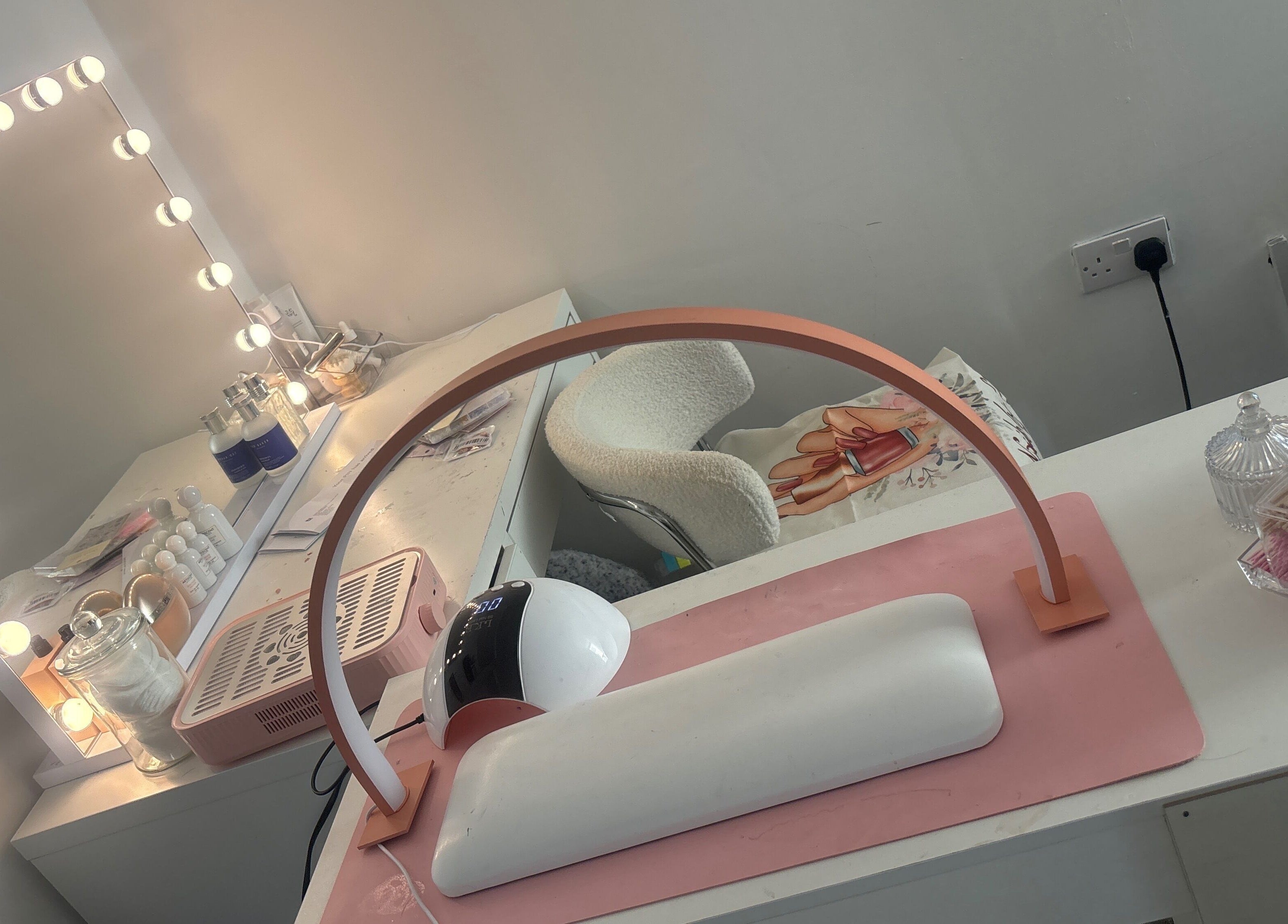 Well-lit manicure station at Nails by ells, Forest Row, England, GB showcasing nail care products and decor.