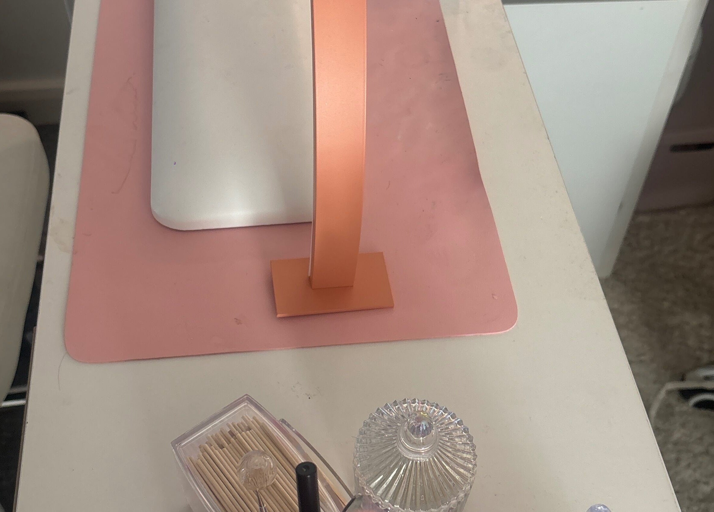 Stylish manicure desk at Nails by Ells, Forest Row, England, GB with pink lamp and accessories.