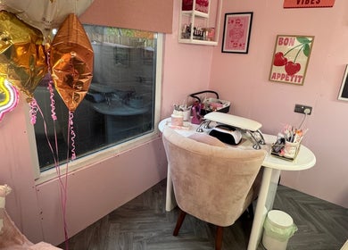 MK Beauty Hut in Coleraine, Northern Ireland, GB showcases a cozy pink-themed nail station with decor.