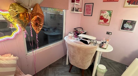 MK Beauty Hut in Coleraine, Northern Ireland, GB showcases a cozy pink-themed nail station with decor.
