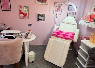 Elegant beauty room at MK Beauty Hut, Coleraine, Northern Ireland, GB, with a comfy chair and vibrant decor.