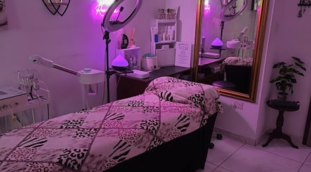 Beauty by Angie therapy room in Raħal Ġdid, MT with spa bed, purple lighting, and ornate mirror.