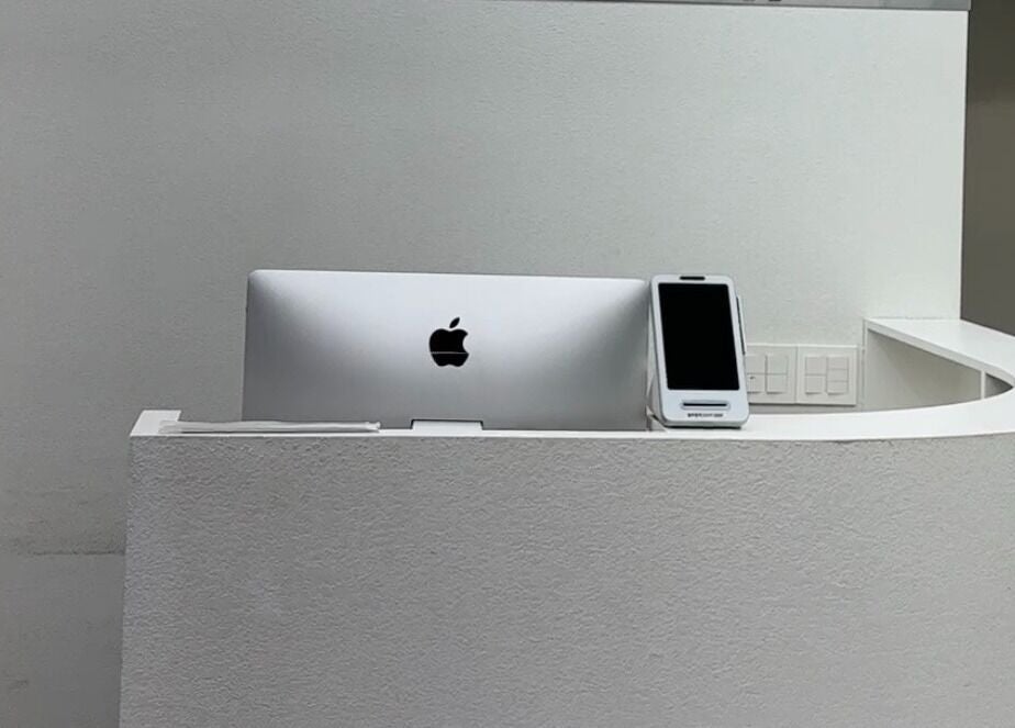 Sophisticated reception desk at qquart hair apgujeong rodeo branch, 서울특별시, KR, with sleek computer setup.