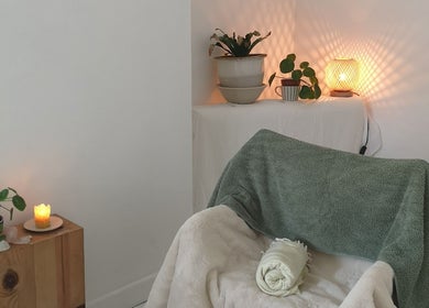 Cozy therapy room at White Dove Holistic Therapies, Bideford, England with candles and plants for relaxation.