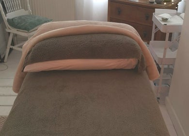 Relaxing massage table at White Dove Holistic Therapies, Bideford, England, GB. Experience ultimate tranquility.