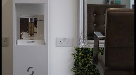 Elegant salon decor at Curly Life London, London, England, GB with stylish brown chair and product display.