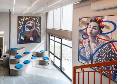 Interior moderno no Haroldo Jr. | Solo Concept em Lisboa, com decoração artística vibrante e assentos azuis.