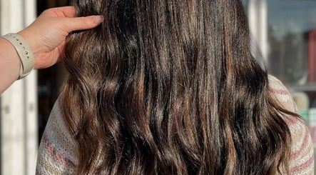Detailed view of wavy, glossy brown hair at Hair by Micaela Rae, East Meadow, New York, US.