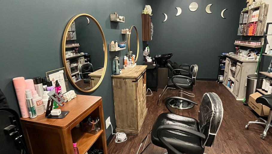 Cozy interior of Hair by Micaela Rae, East Meadow, New York, US with stylish mirrors and salon chairs.