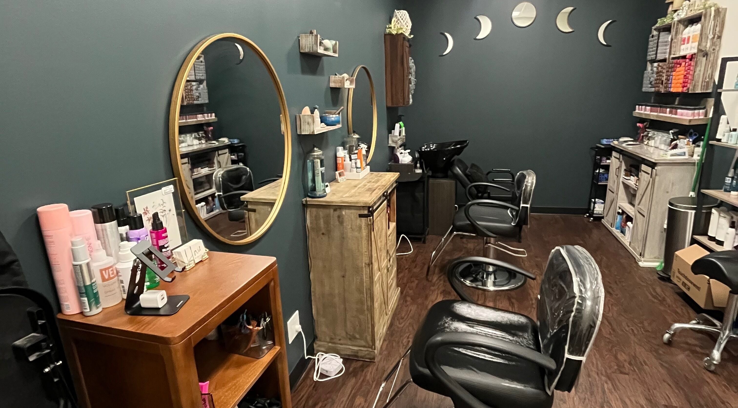 Cozy interior of Hair by Micaela Rae, East Meadow, New York, US with stylish mirrors and salon chairs.