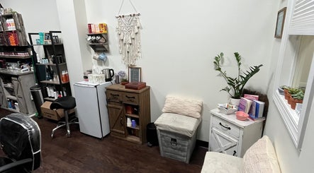 Cozy salon corner at Hair by Micaela Rae, East Meadow, New York, US with elegant decor and comfortable seating.
