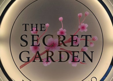 Illuminated logo of The Secret Garden Wellness Studio, Randalstown, Northern Ireland with cherry blossoms.