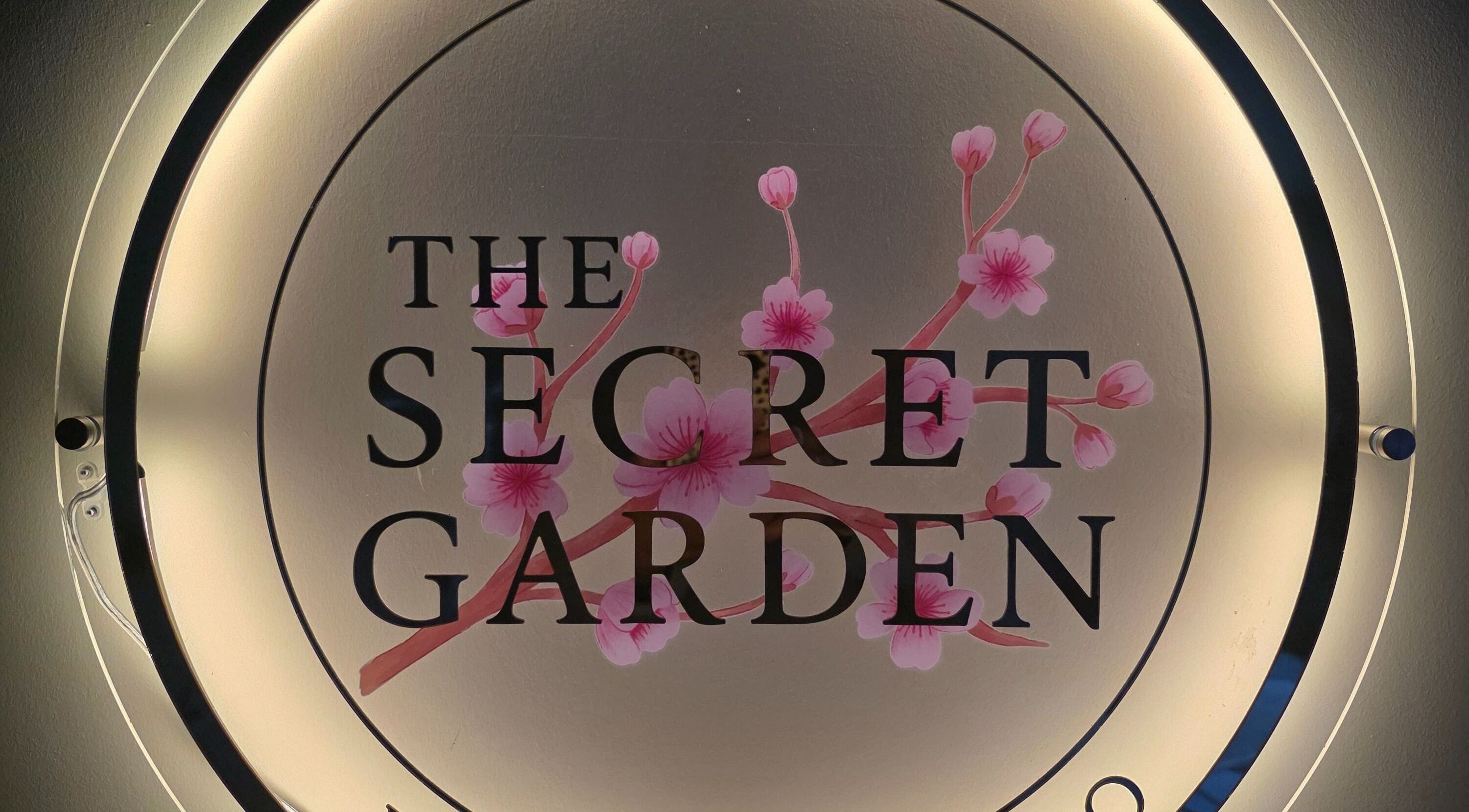 Illuminated logo of The Secret Garden Wellness Studio, Randalstown, Northern Ireland with cherry blossoms.