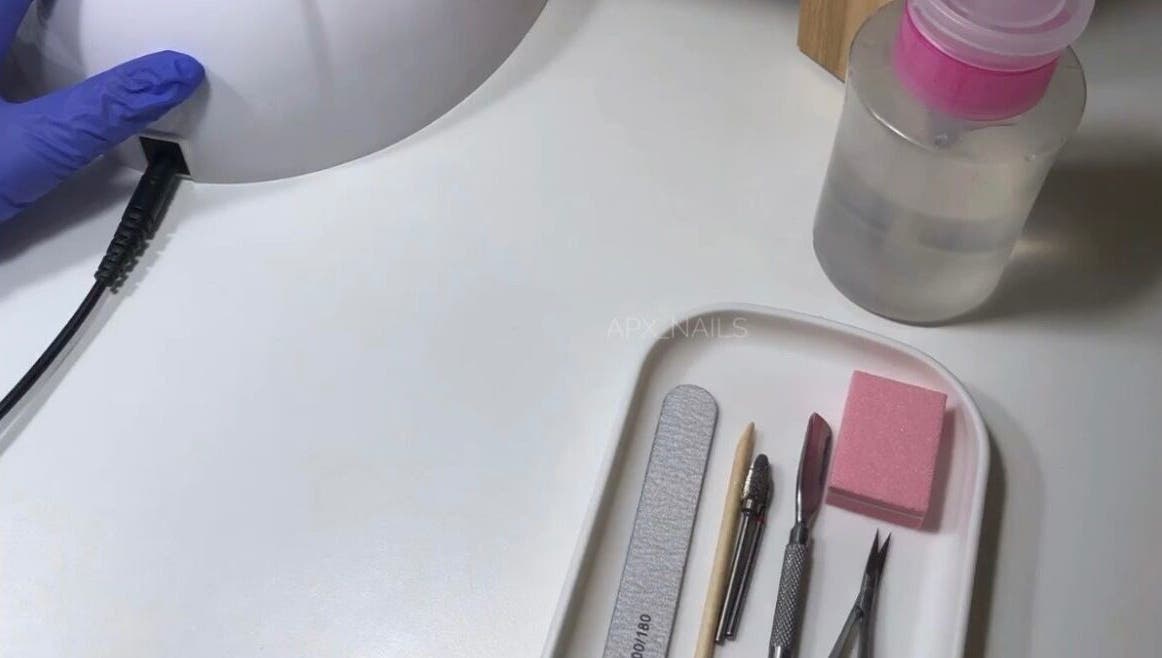 Nail care tools and UV lamp at Jaytee’s Beauty Bar, Rustenburg, North West, ZA, offer professional manicure services.