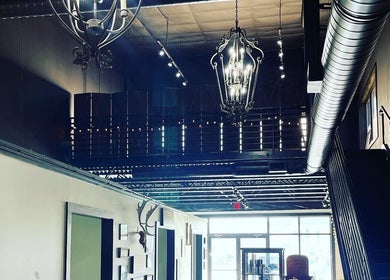 Industrial chic interior of Outlaw Art Tattoo and Piercing, Lebanon, Tennessee, US, showcasing stylish decor.