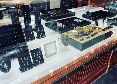 Jewelry display case at Outlaw Art Tattoo and Piercing in Lebanon, Tennessee, US featuring assorted pieces.