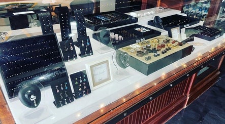 Jewelry display case at Outlaw Art Tattoo and Piercing in Lebanon, Tennessee, US featuring assorted pieces.