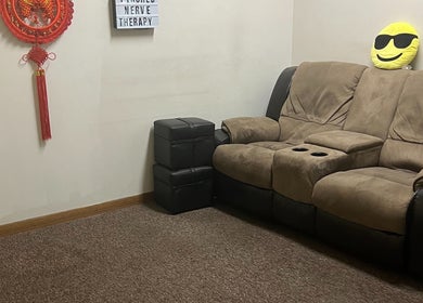 Comfortable seating area at Chinese Massage Oasis in Salt Lake City, Utah, US with a plush sofa and decor.