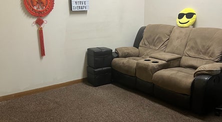Comfortable seating area at Chinese Massage Oasis in Salt Lake City, Utah, US with a plush sofa and decor.
