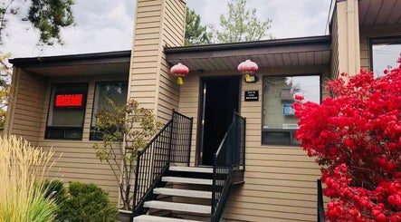 Entrance of Chinese Massage Oasis with vibrant plants, located in Salt Lake City, Utah, US.