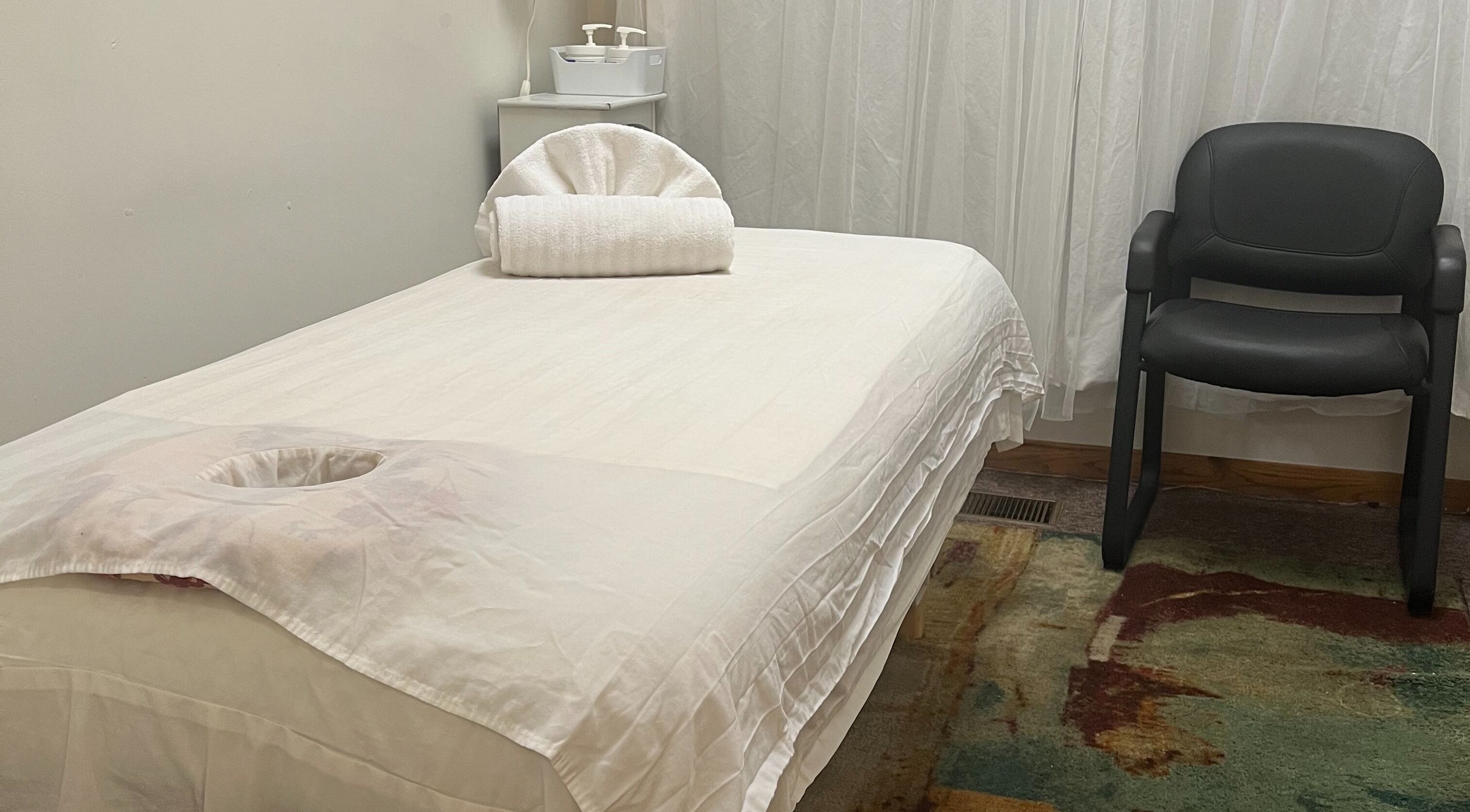 Tranquil massage room at Chinese Massage Oasis in Salt Lake City, Utah, US with a neatly prepared massage table.