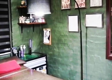 Interior of Black Ice Tattoos and Body Piercings Studio in Krugersdorp, Gauteng, ZA with green walls and decor.