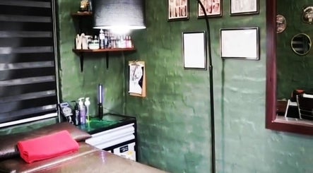 Interior of Black Ice Tattoos and Body Piercings Studio in Krugersdorp, Gauteng, ZA with green walls and decor.