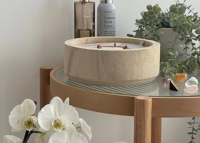Relaxing decor with a wooden candle and plants at Glamour Nails in Rochester, England, GB.