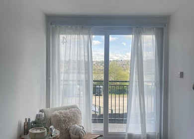 Tranquil view from Glamour Nails in Rochester, England, GB featuring sheer curtains and peaceful outdoor scenery.