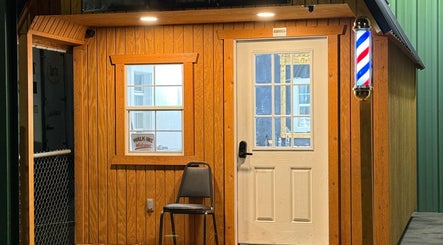 Front of DUKES TRADITIONAL BARBERSHOP in Canby, Oregon, US, featuring a welcoming chair and classic barber pole.