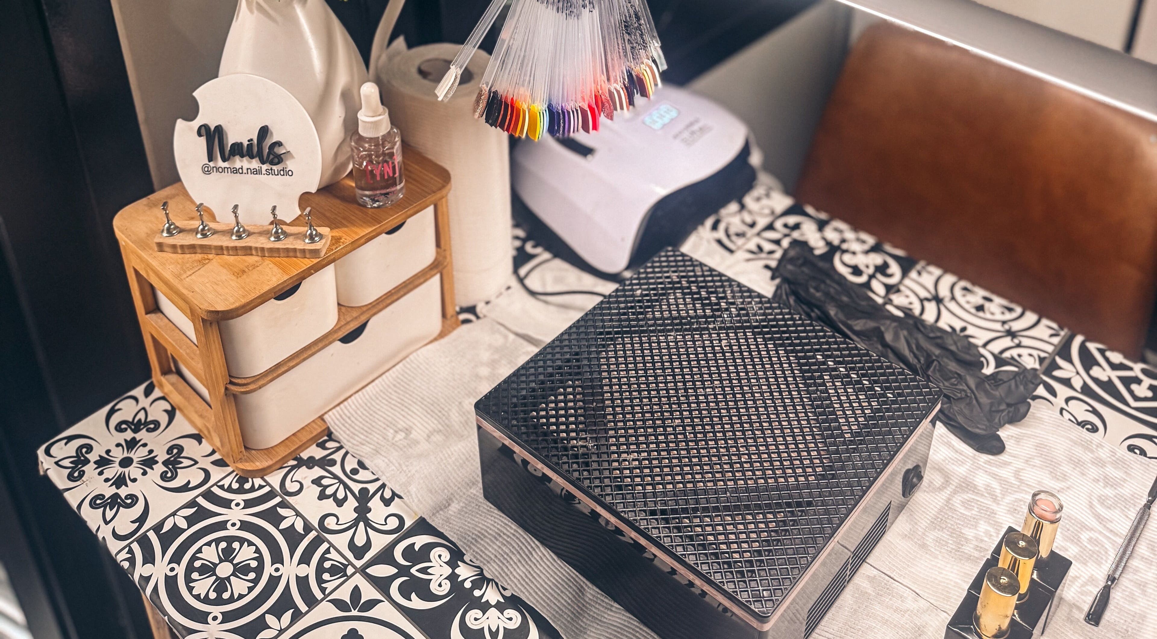 Elegant nail station at Nomad Nail Studio, Maryborough, Queensland, AU with tools and polish displays.