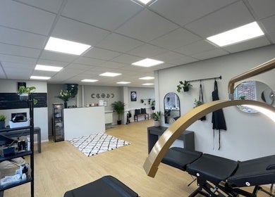Chic interior of beauty lounge by abs in Garforth, England, GB with modern decor and treatment beds.