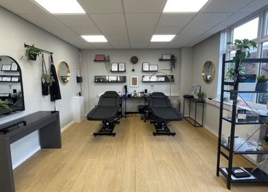 Elegant treatment room at beauty lounge by abs, Garforth, England, GB, featuring two modern spa chairs.