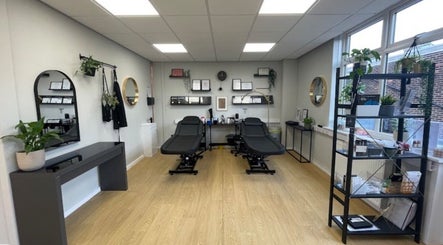 Elegant treatment room at beauty lounge by abs, Garforth, England, GB, featuring two modern spa chairs.