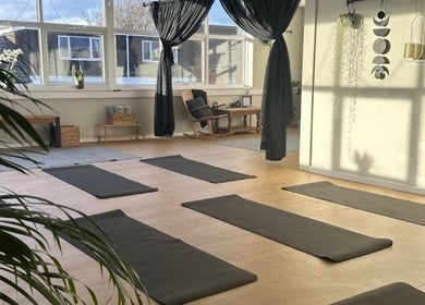 Yoga room at beauty lounge by abs, Garforth, England, GB, with mats and natural light.