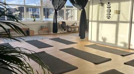 Yoga room at beauty lounge by abs, Garforth, England, GB, with mats and natural light.