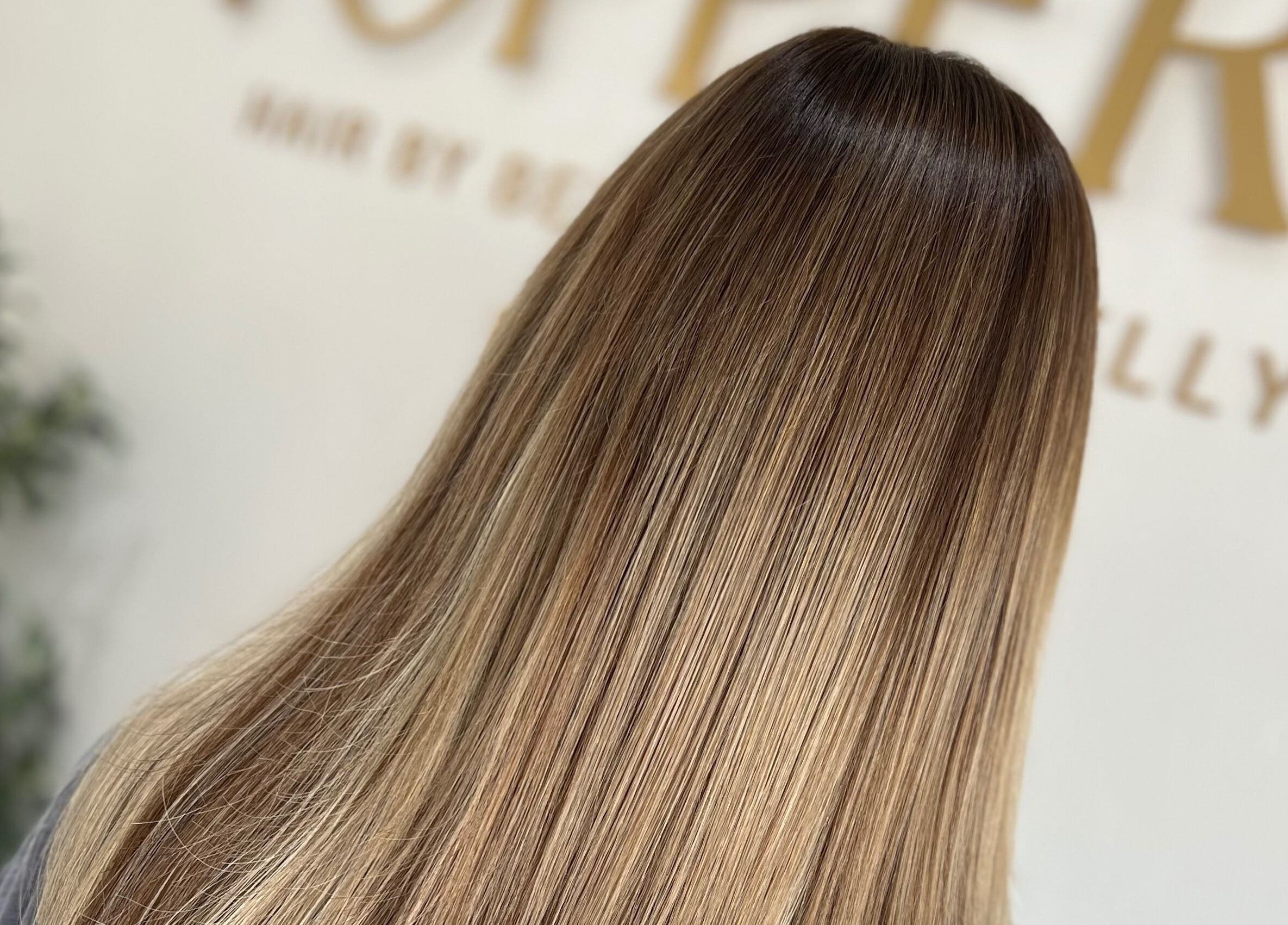Smooth, shiny hair at Kelly Guppy Hair in Exeter, England, GB showcasing expert hair styling.