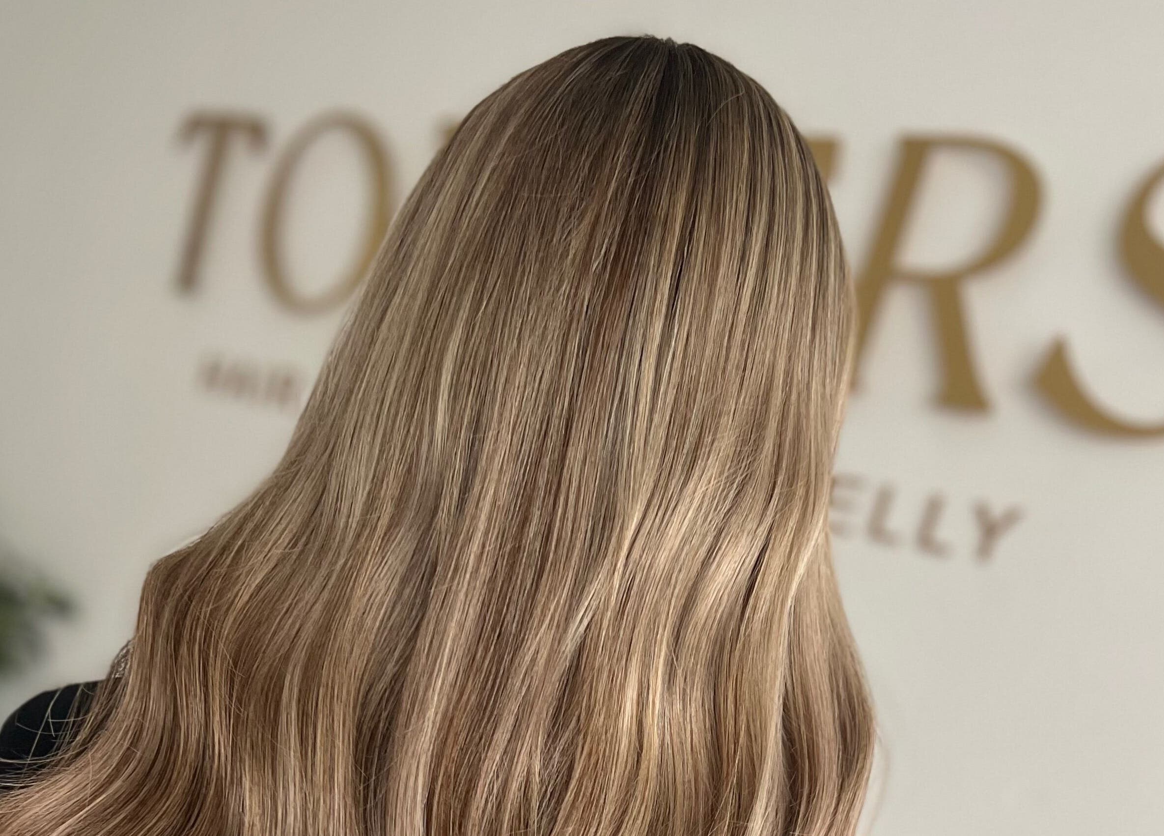 Silky blonde hair showcased at Kelly Guppy Hair, Exeter, England, GB, highlighting expert styling.