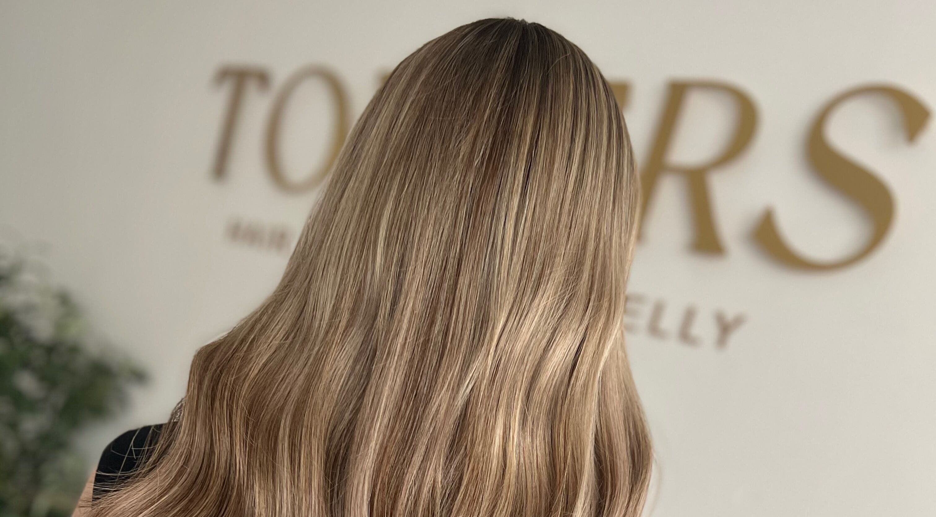 Silky blonde hair showcased at Kelly Guppy Hair, Exeter, England, GB, highlighting expert styling.