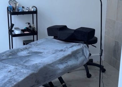 Cozy treatment room at Beauty_bymeg5, Maryport, England, GB, featuring a massage table and beauty supplies.