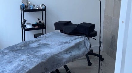 Cozy treatment room at Beauty_bymeg5, Maryport, England, GB, featuring a massage table and beauty supplies.