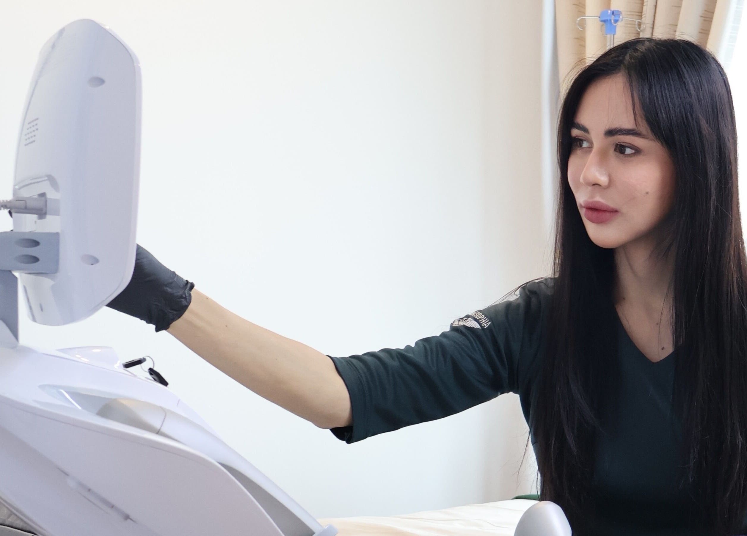 Professional technician at Zara Aesthetic, Kuala Lumpur, operating advanced beauty equipment.