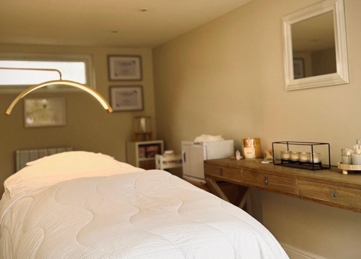 Elegant treatment room at Kalma, Braintree, England, GB, featuring a cozy massage table and ambient lighting.