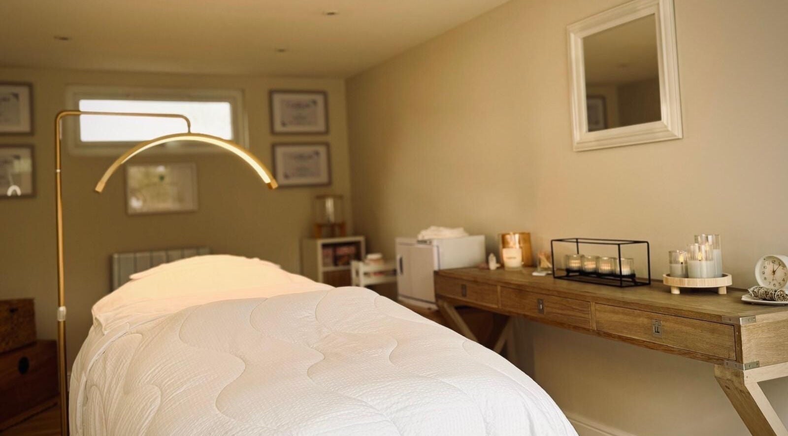 Elegant treatment room at Kalma, Braintree, England, GB, featuring a cozy massage table and ambient lighting.