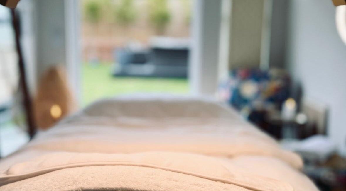 Relaxing massage bed at Kalma spa in Braintree, England, GB, overlooking a peaceful garden.