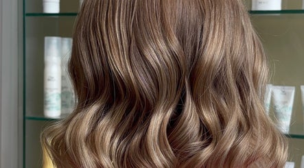 Stylish wavy hairstyle at Belle Grace Hairdressing, Denton, England, GB. Vibrant curls showcase expert hairdressing.
